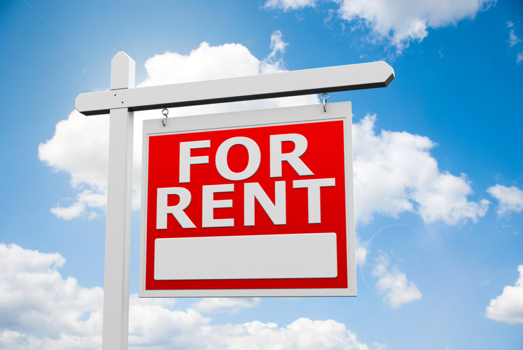For Rent sign with blue sky background